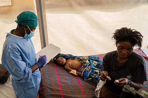 Mpox outbreak: A health worker attends to a girl suffering from mpox in Congo